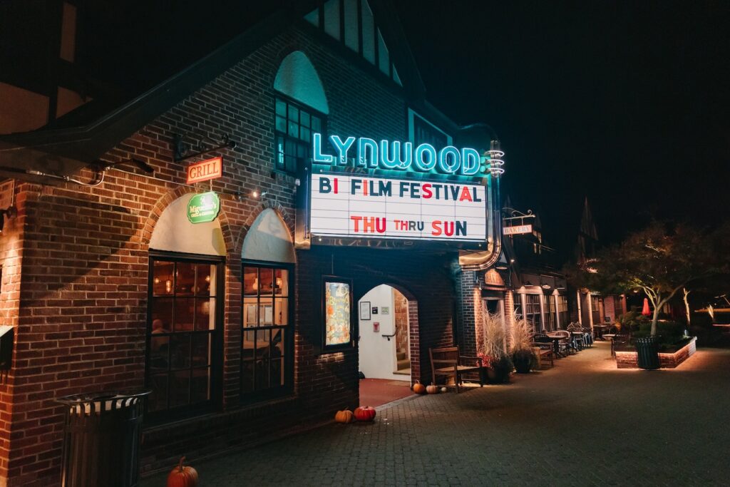 Glowing marquee of the Lynwood theater at night which reads "BI FILM FEST THUR to SUN"